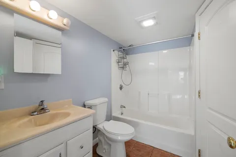 a bathroom with a sink toilet tub and shower