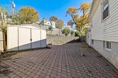 a view of a house with a backyard