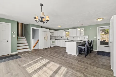 a view of kitchen with cabinets and wooden floor