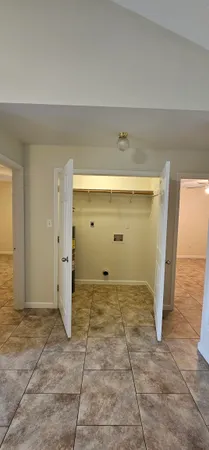 a backyard of a house with table and chairs