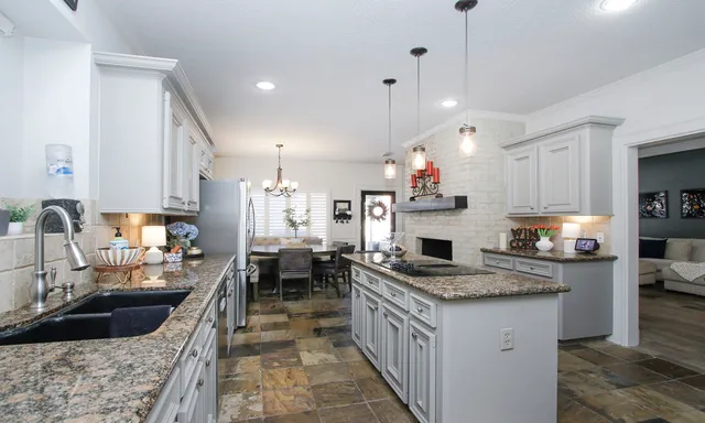 a spacious bedroom with a bed a couch and a chandelier