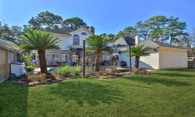 a view of a house with a yard and sitting area
