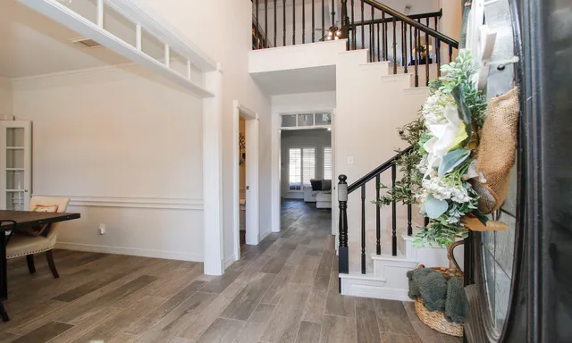 a view of entryway and hall with wooden floor