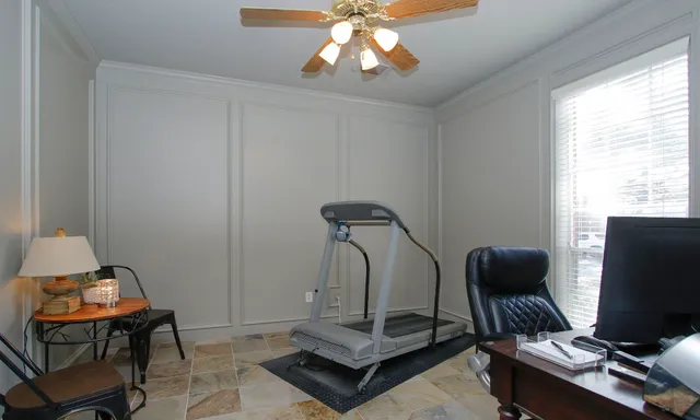a view of a workspace with furniture and a window