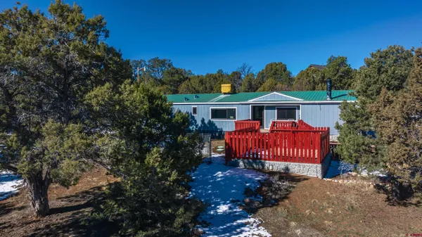 a view of a house with a yard and deck