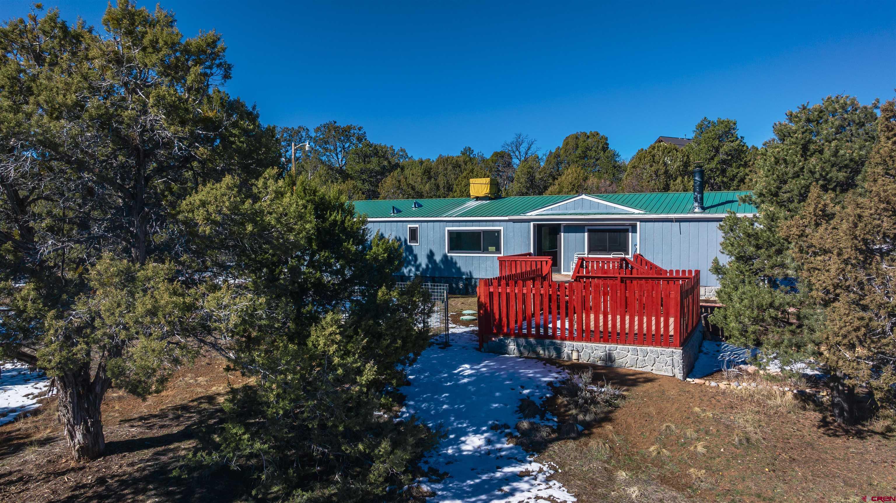 a view of a house with a yard and deck
