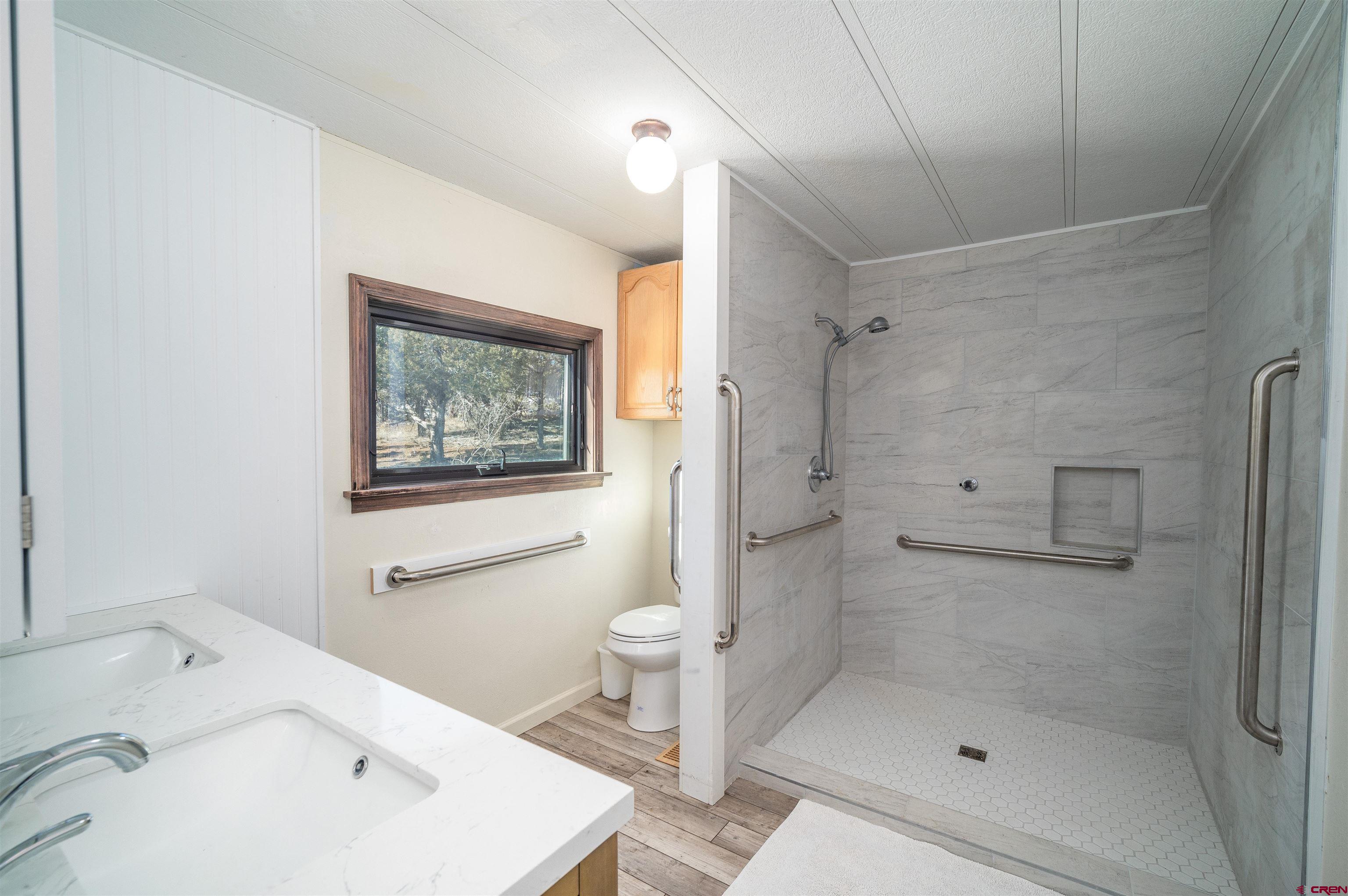 253 Valley Place Durango, CO 81303 - Photo 14 of 26 a bathroom with a sink a toilet and shower
