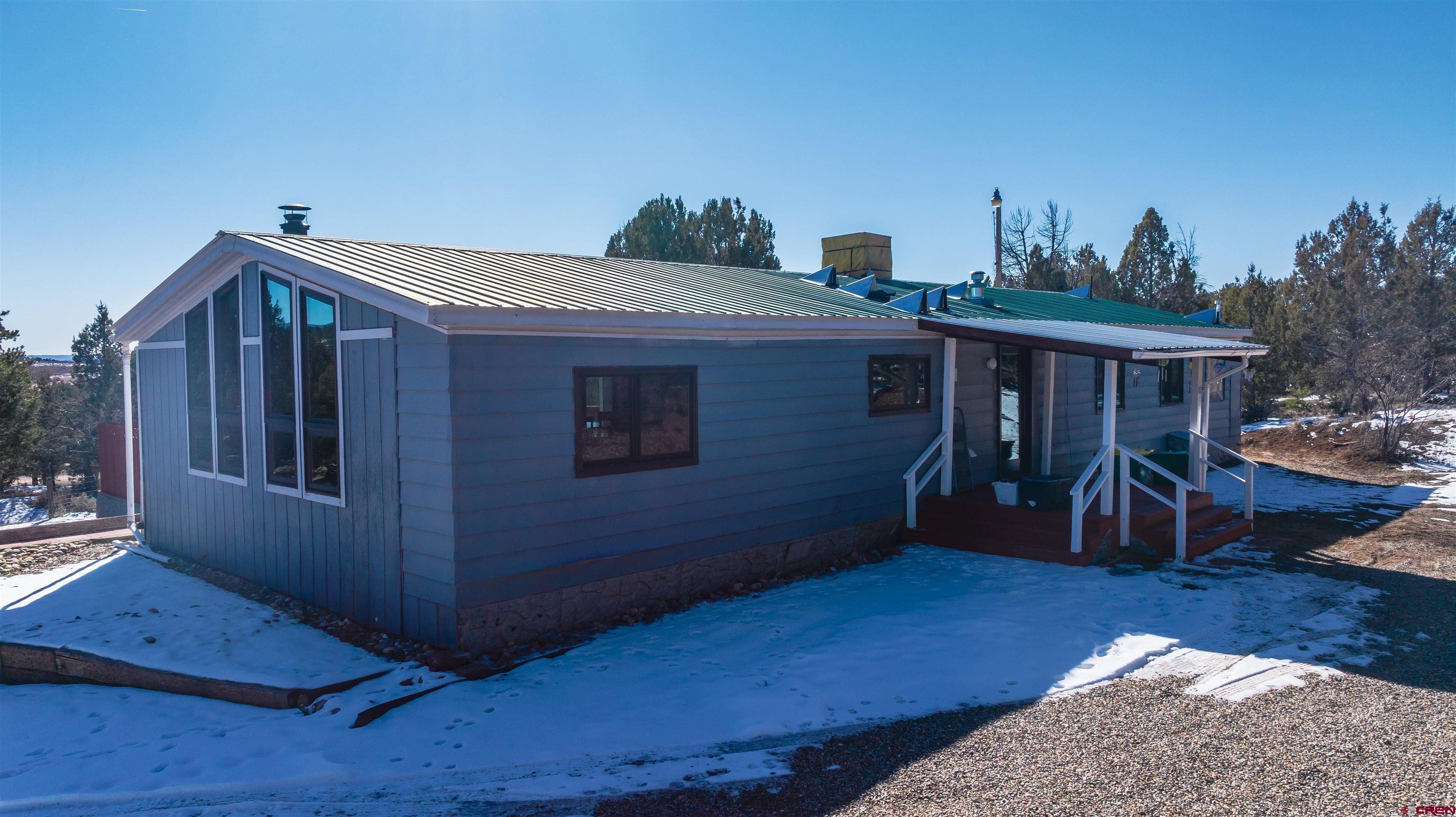 253 Valley Place Durango, CO 81303 - Photo 2 of 26 a view of a house with wooden floor and a roof deck