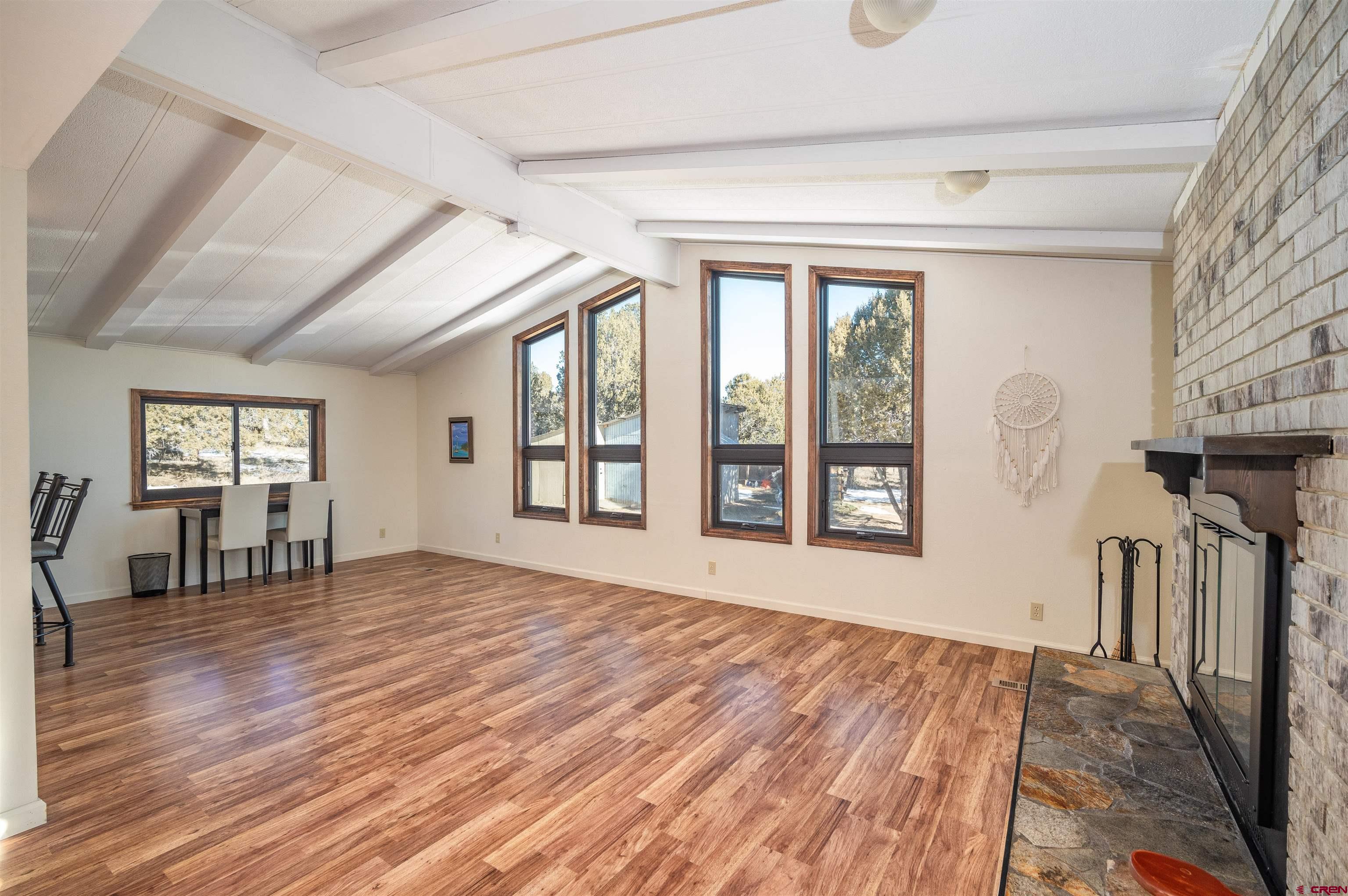 253 Valley Place Durango, CO 81303 - Photo 4 of 26 a view of empty room with wooden floor and fan