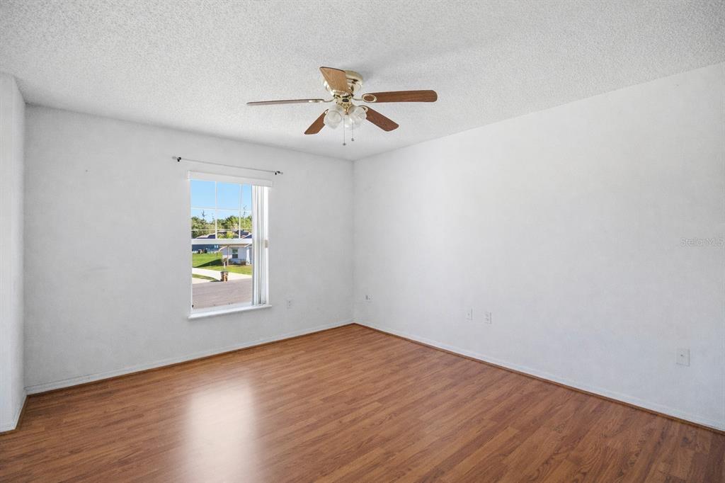 206 Taranto Way Kissimmee, FL 34758 - Photo 19 of 45 an empty room with window and wooden floor