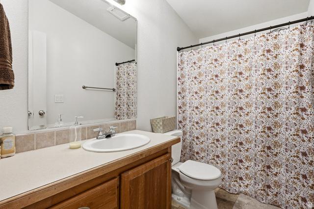 1637 East Midvalley Road Enoch, UT 84721 - Photo 29 of 48 Full bathroom featuring vanity and a shower with shower curtain