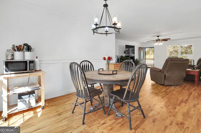 a view of a dining room with furniture and wooden floor