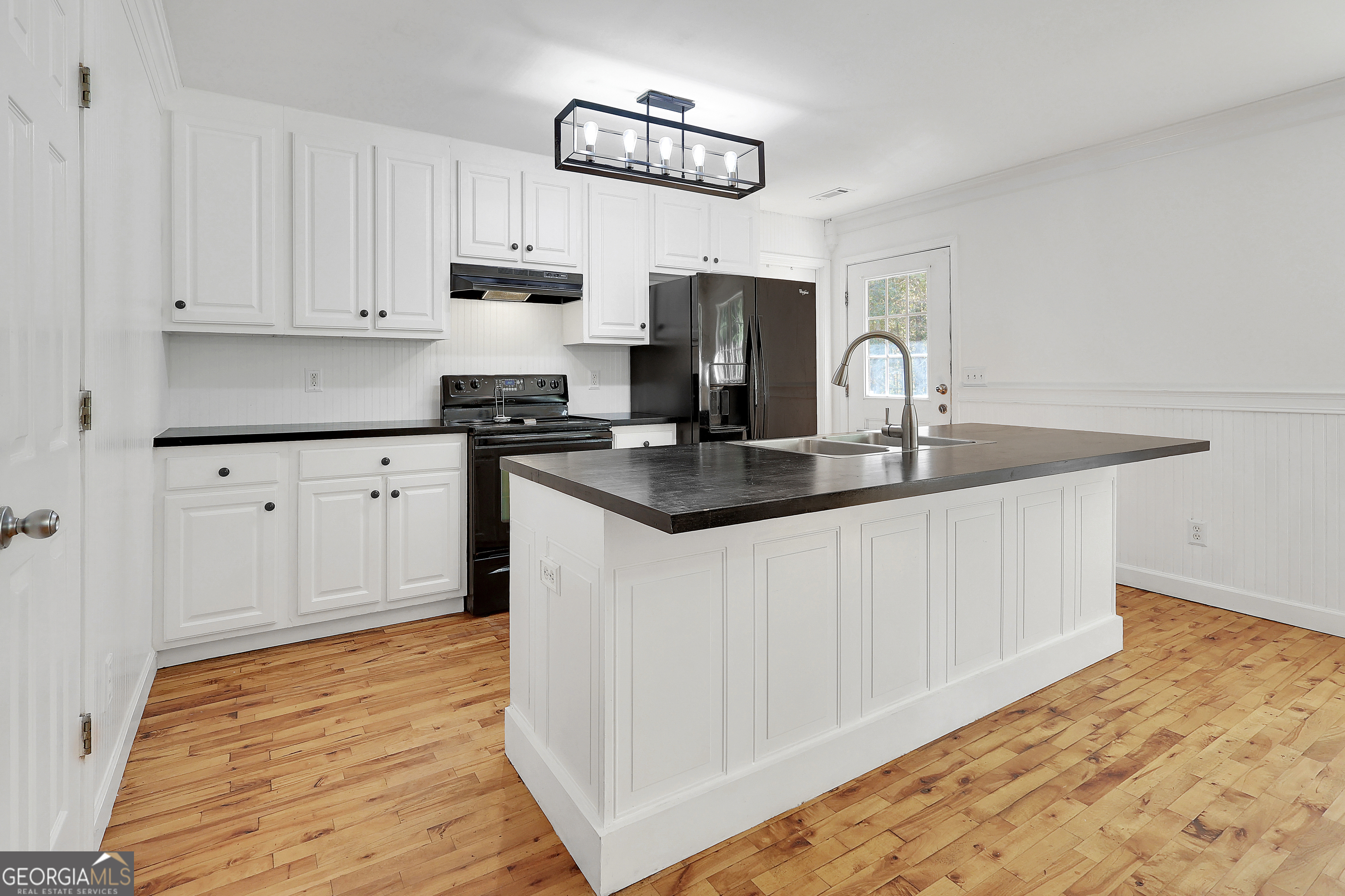 394 Burg Road Locust Grove, GA 30248 - Photo 20 of 40 a kitchen with granite countertop a stove a sink and a white cabinets