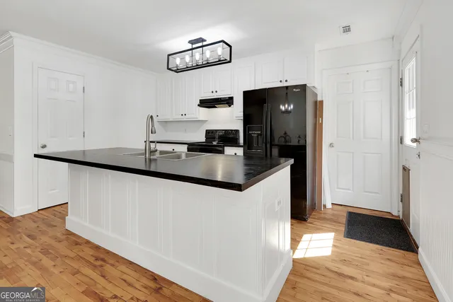 a kitchen with stainless steel appliances a refrigerator sink and microwave