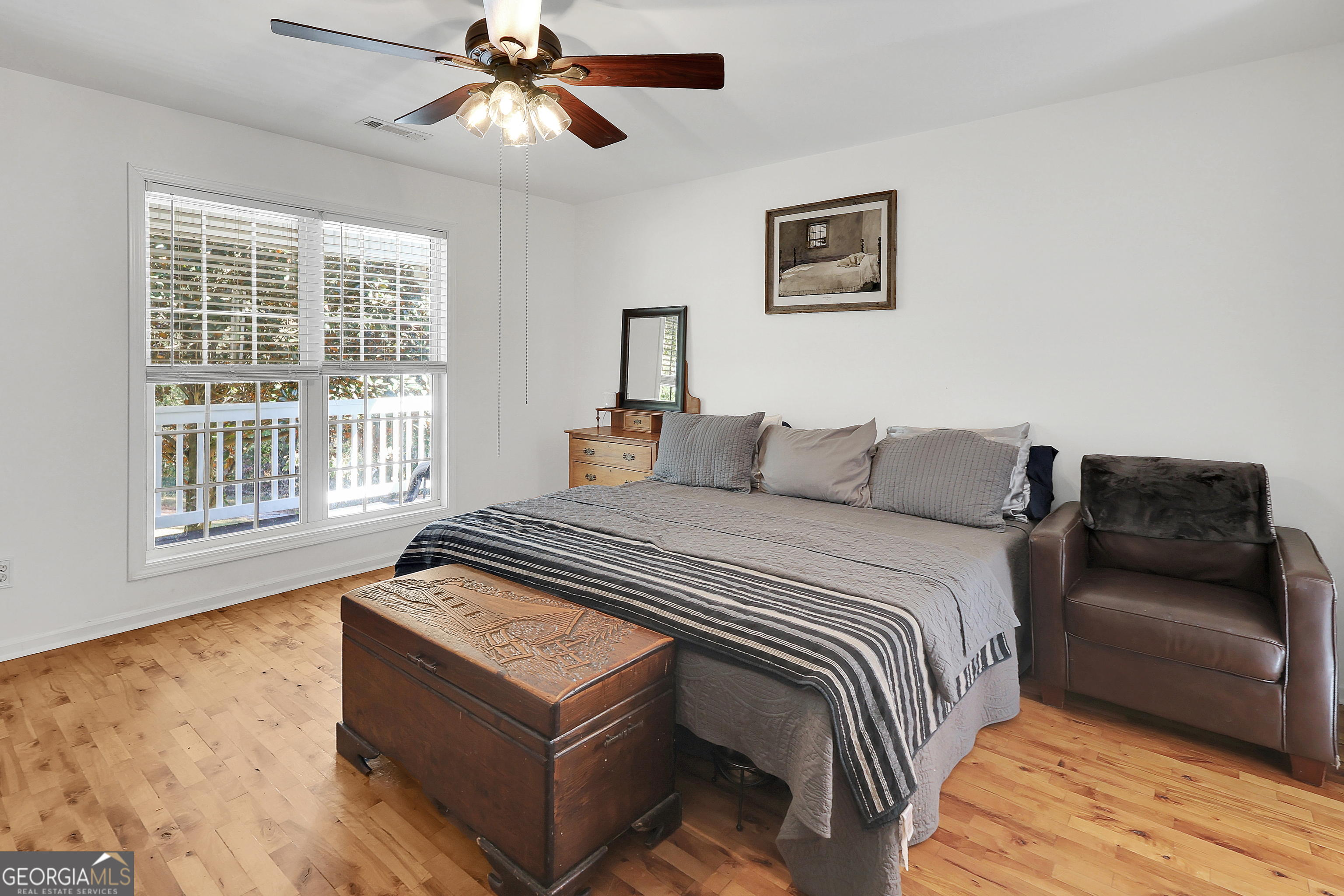 394 Burg Road Locust Grove, GA 30248 - Photo 23 of 40 a bedroom with a bed and wooden floor