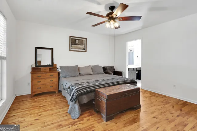 a spacious bedroom with a bed and a chandelier