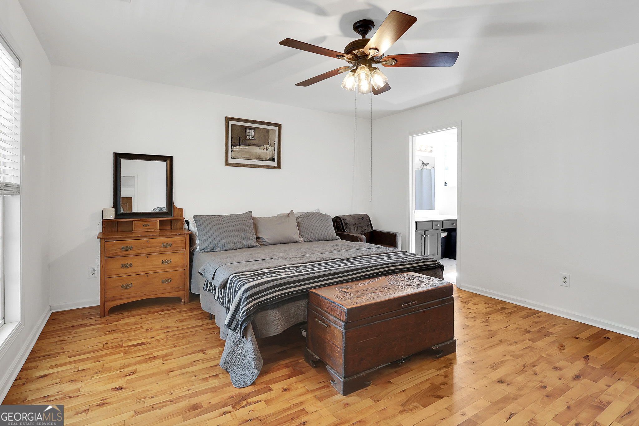 394 Burg Road Locust Grove, GA 30248 - Photo 24 of 40 a spacious bedroom with a bed and a chandelier