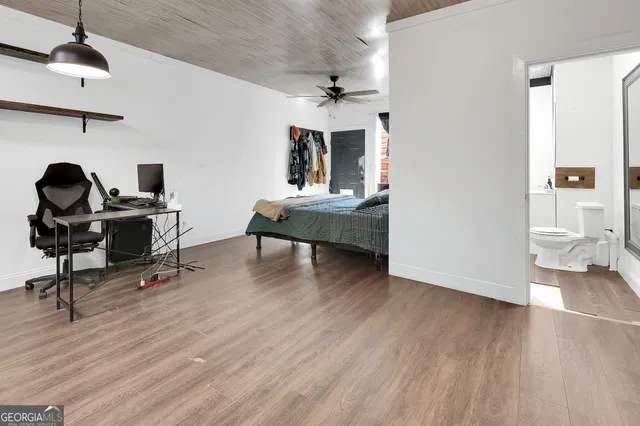 a view of a workspace with furniture and wooden floor