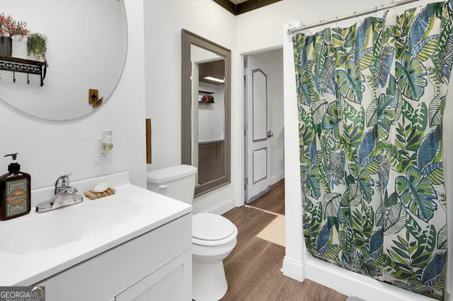 a bathroom with a sink toilet and shower