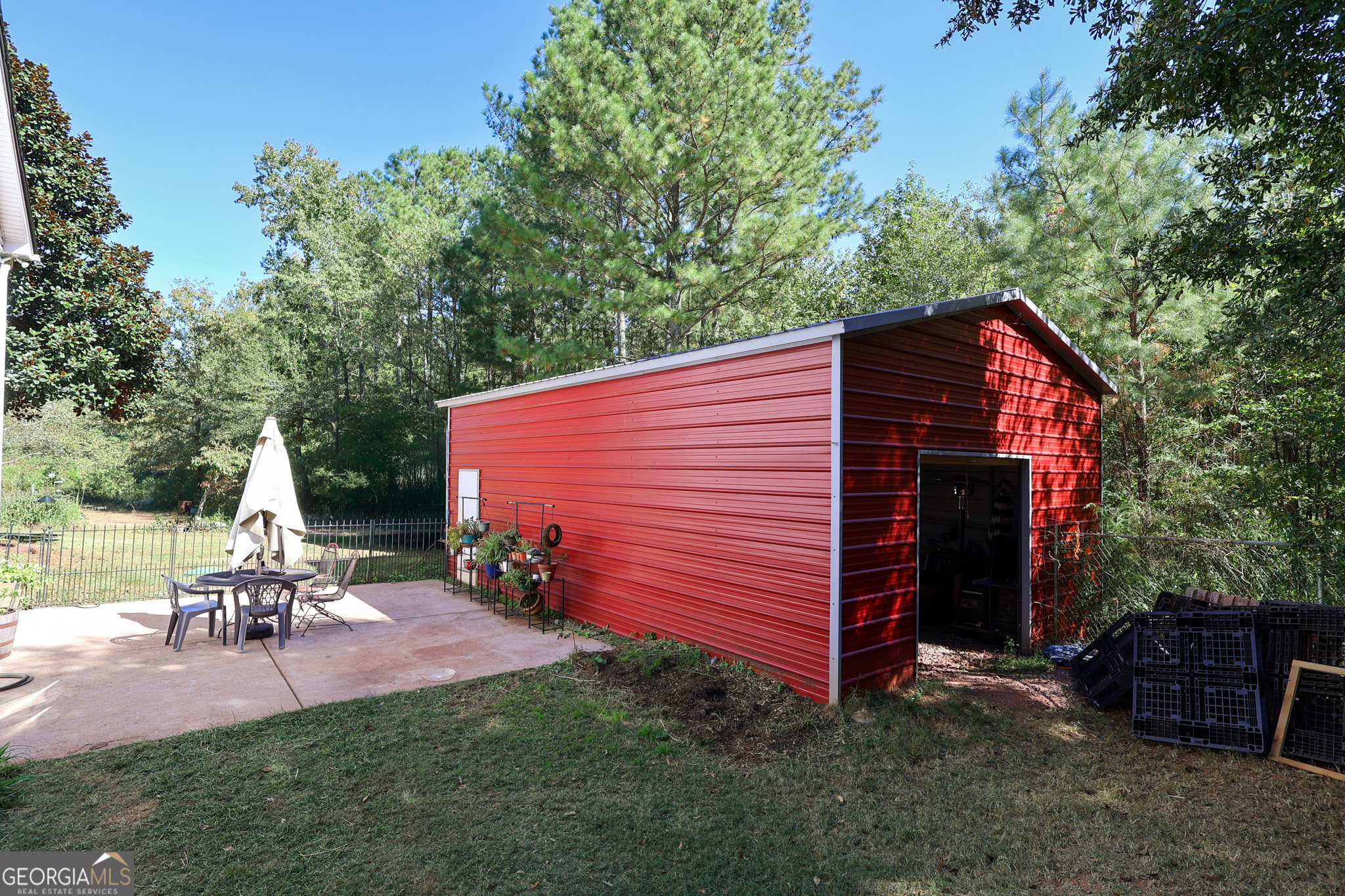 394 Burg Road Locust Grove, GA 30248 - Photo 10 of 40 a view of backyard with a table and chairs under an umbrella