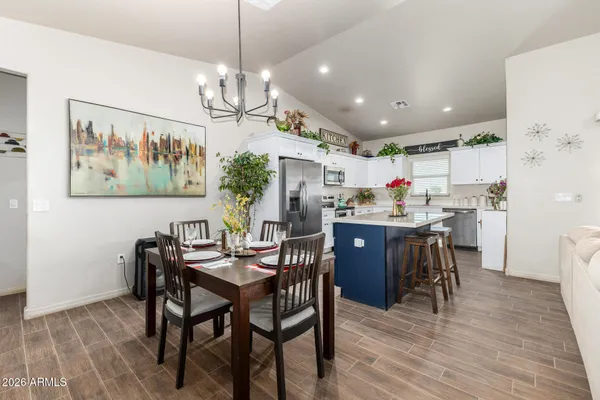 a kitchen with refrigerator and cabinets