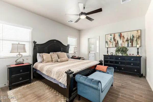 a bedroom with a bed and a chandelier