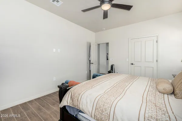 a bedroom with a bed and ceiling fan