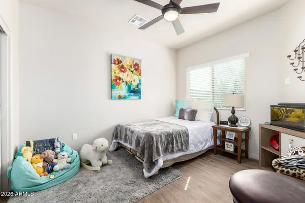 a bedroom with a bed and wooden floor