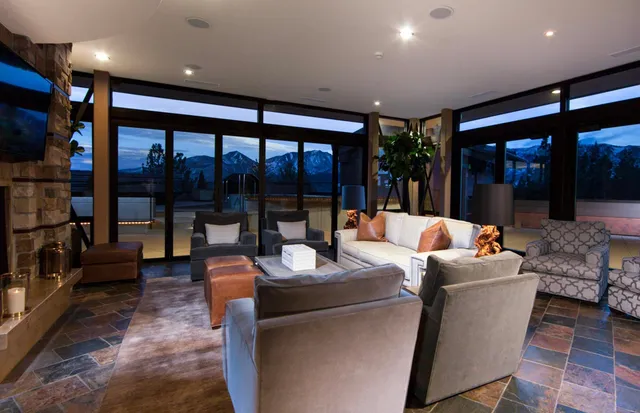 a living room with furniture and a floor to ceiling window