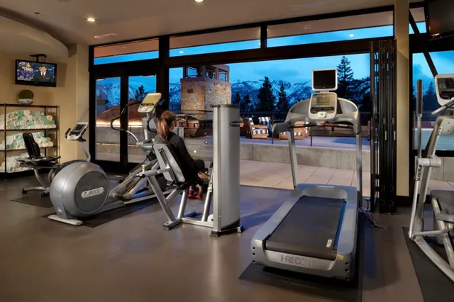a room with pool table and windows