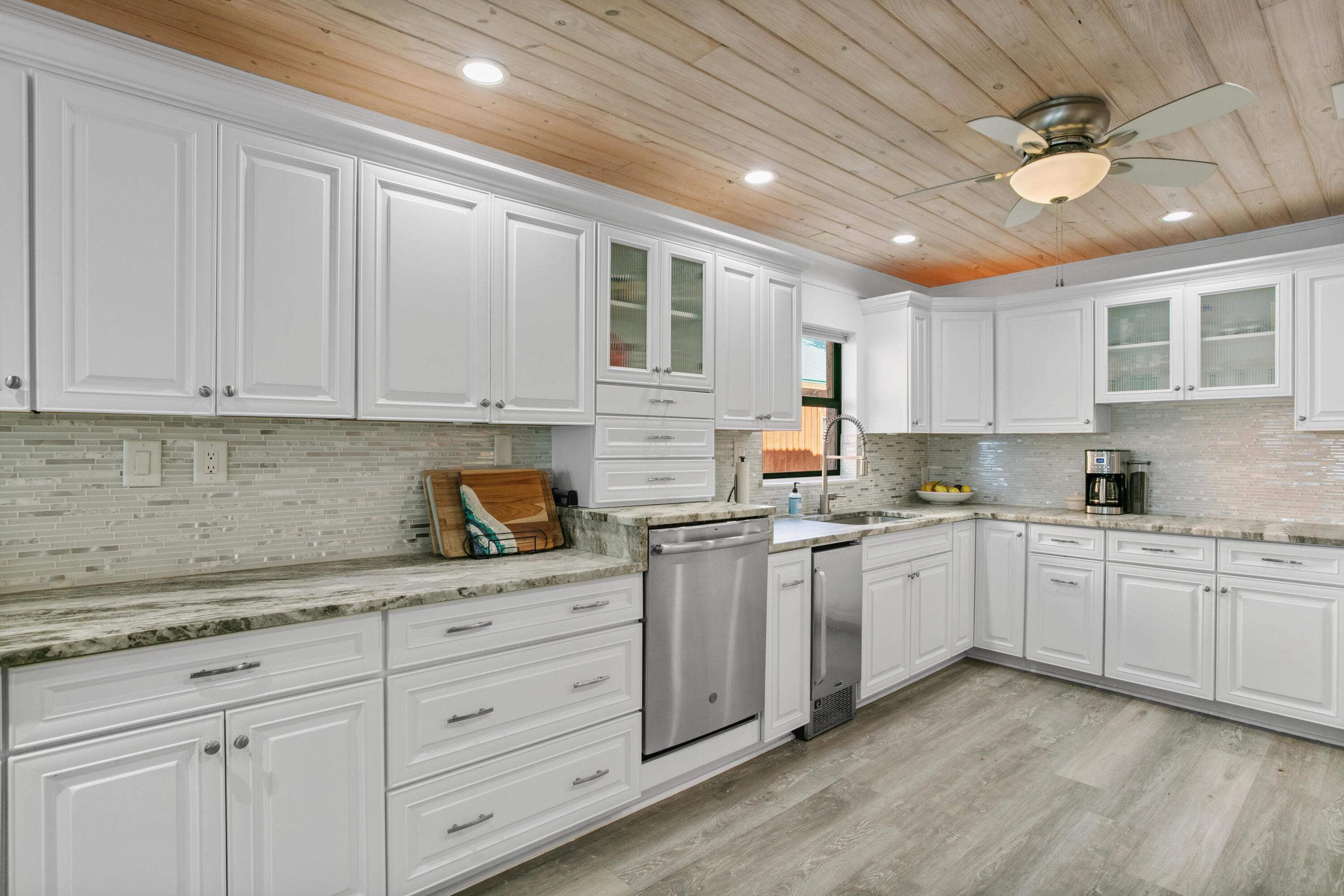 41 Waterview Place Freeport, FL 32439 - Photo 13 of 74 a kitchen with granite countertop white cabinets and white stainless steel appliances