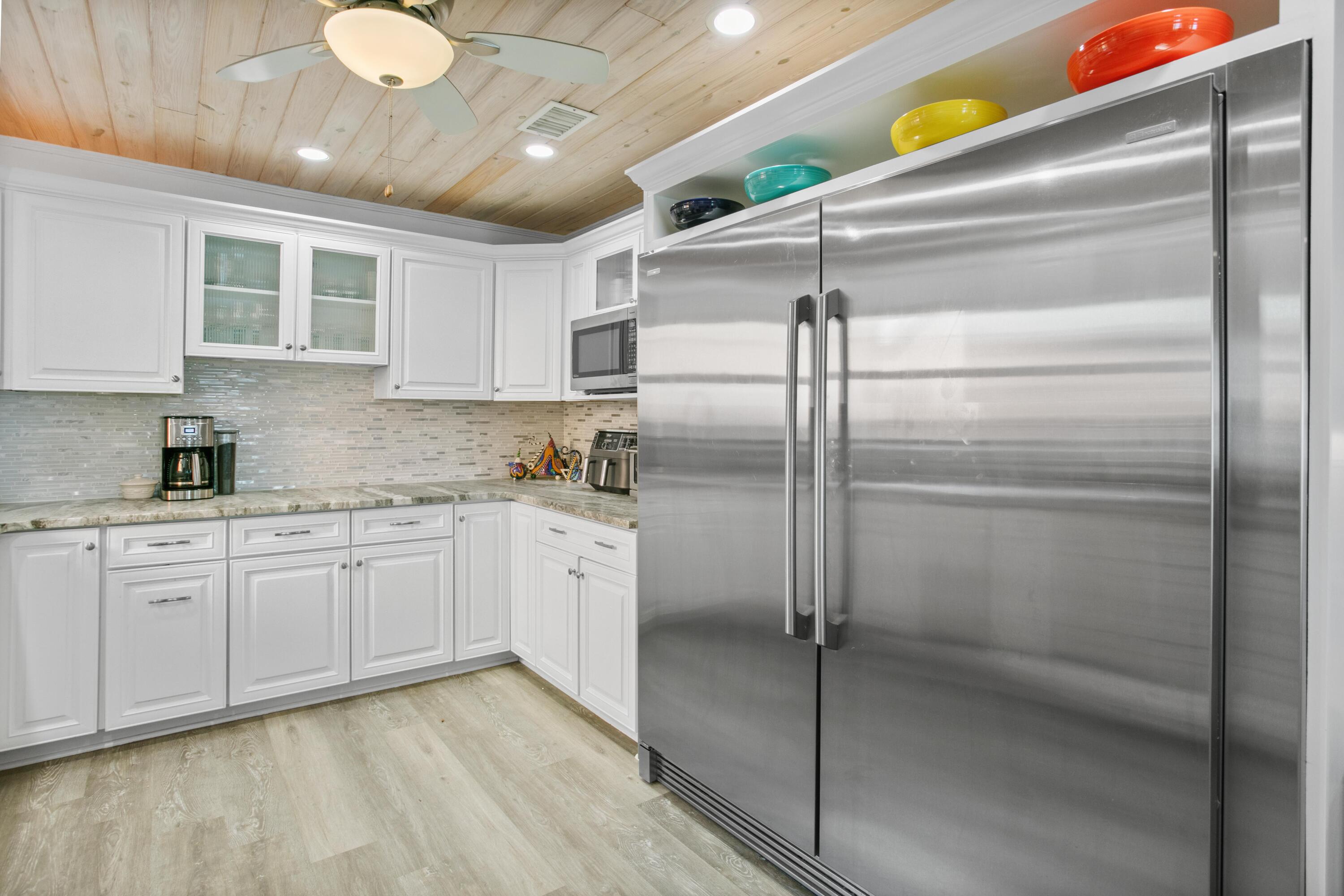 41 Waterview Place Freeport, FL 32439 - Photo 14 of 74 a kitchen with cabinets and stainless steel appliances