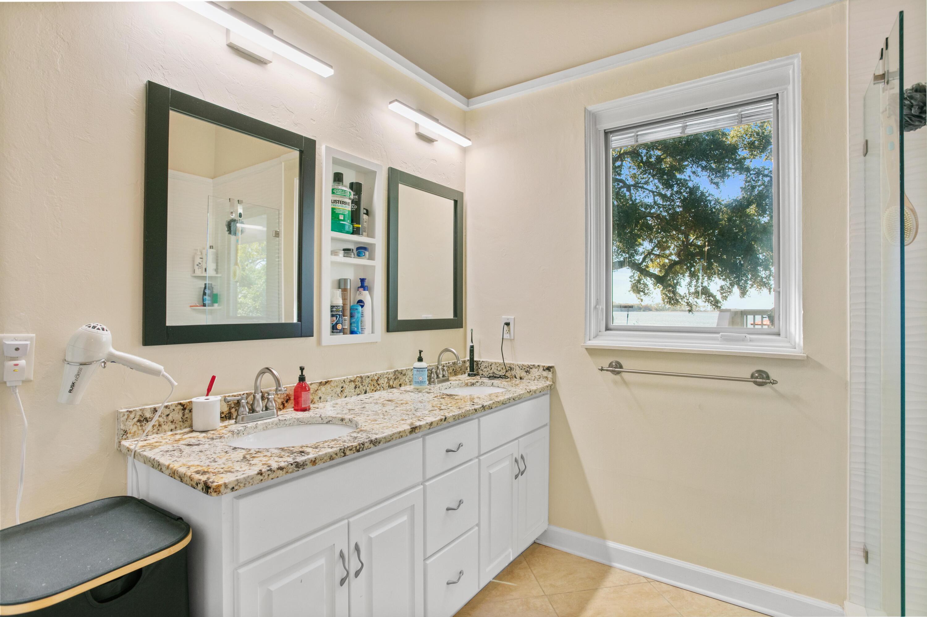 41 Waterview Place Freeport, FL 32439 - Photo 25 of 74 a bathroom with a granite countertop sink mirror and a window