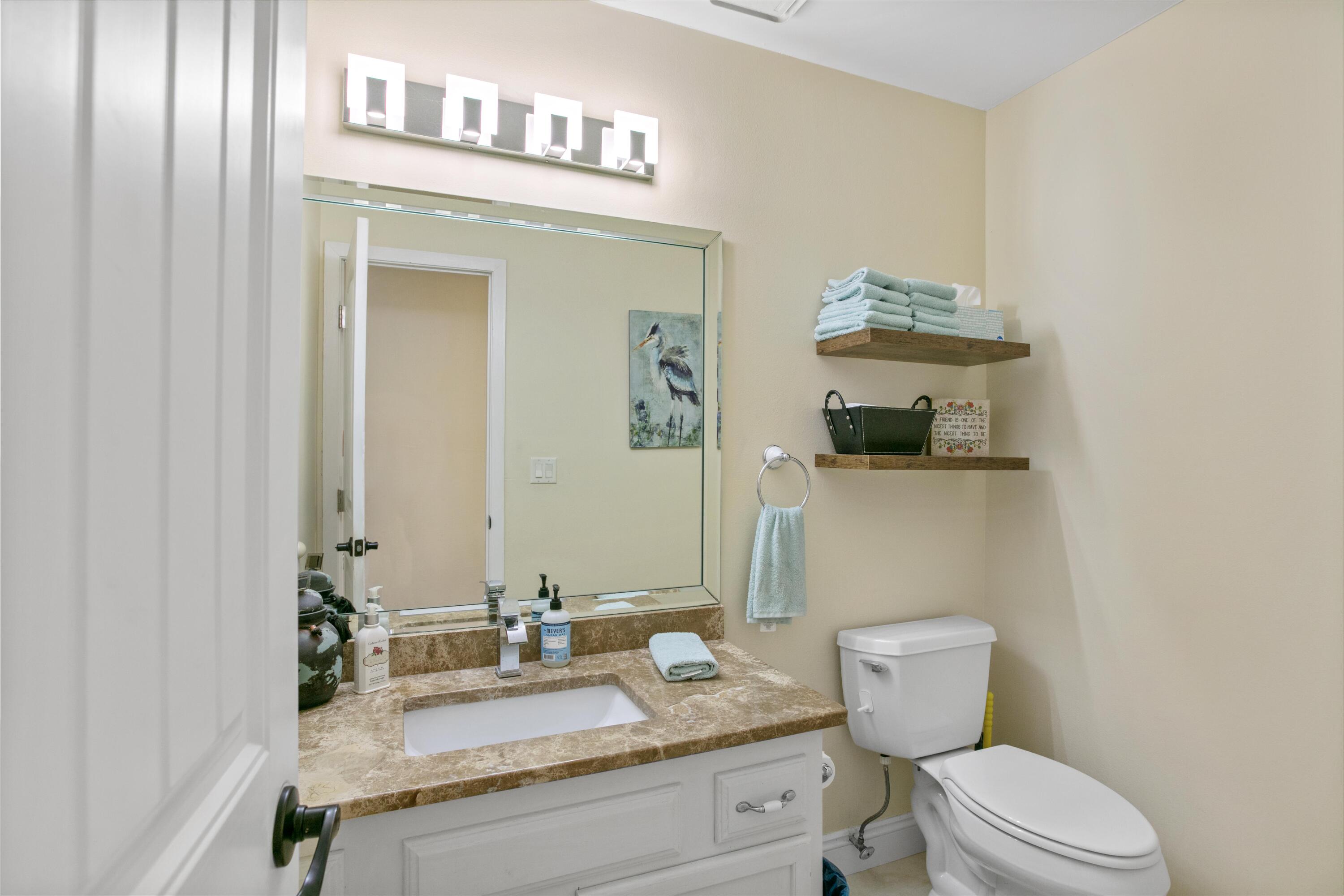 41 Waterview Place Freeport, FL 32439 - Photo 36 of 74 a bathroom with a granite countertop toilet sink and mirror