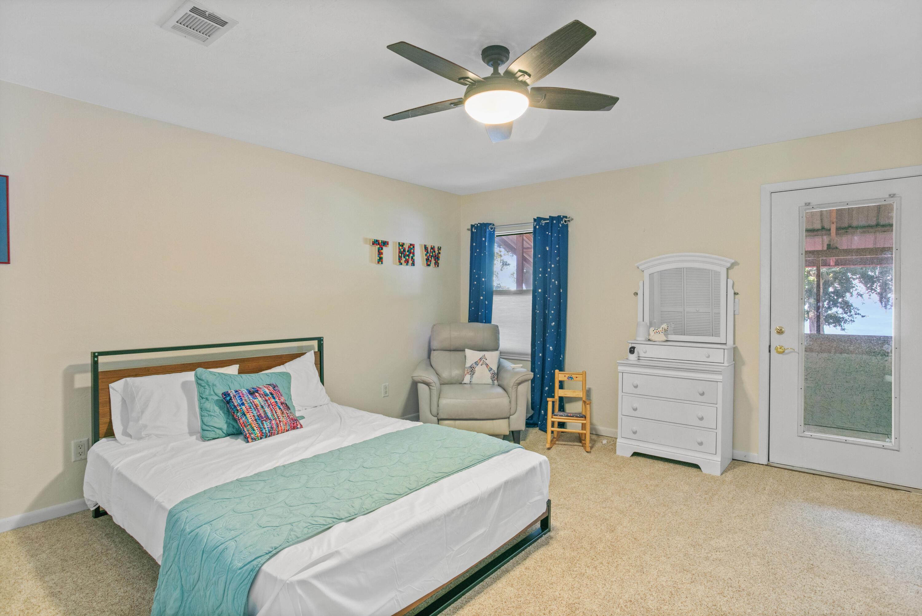 41 Waterview Place Freeport, FL 32439 - Photo 37 of 74 a bedroom with a bed and a chandelier