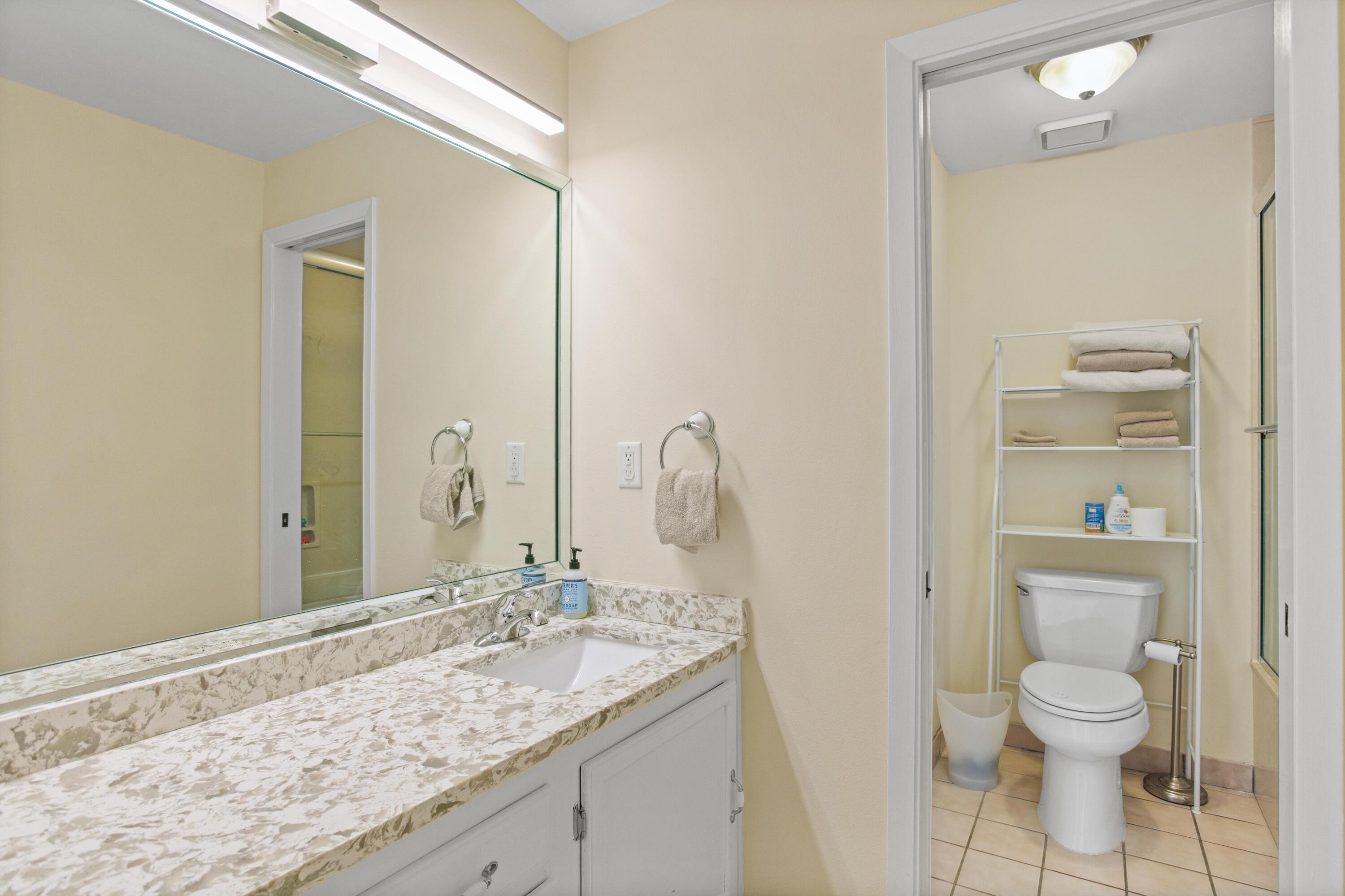 41 Waterview Place Freeport, FL 32439 - Photo 39 of 74 a bathroom with a granite countertop sink a toilet and a mirror