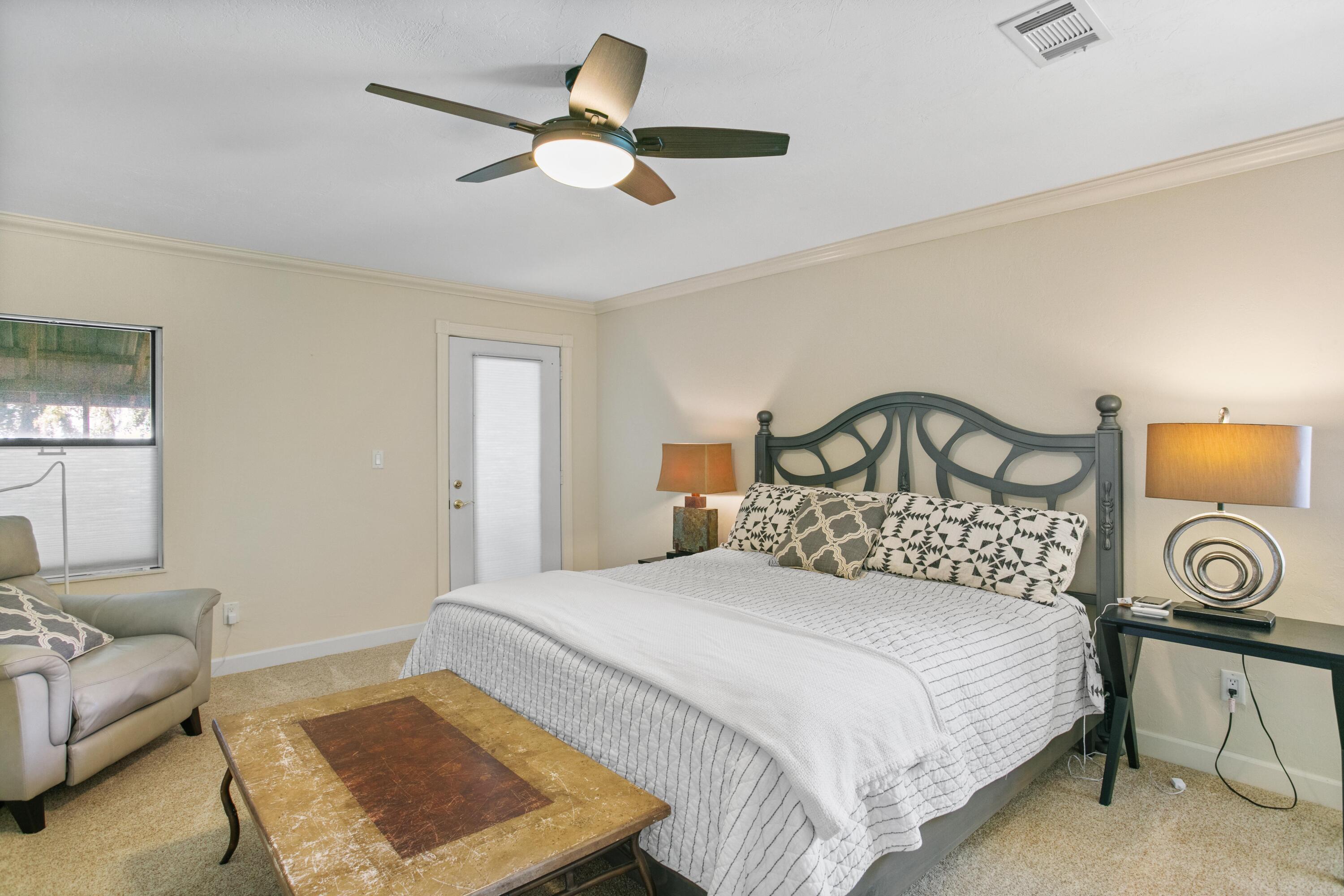 41 Waterview Place Freeport, FL 32439 - Photo 40 of 74 a bedroom with a bed a couch and a chandelier