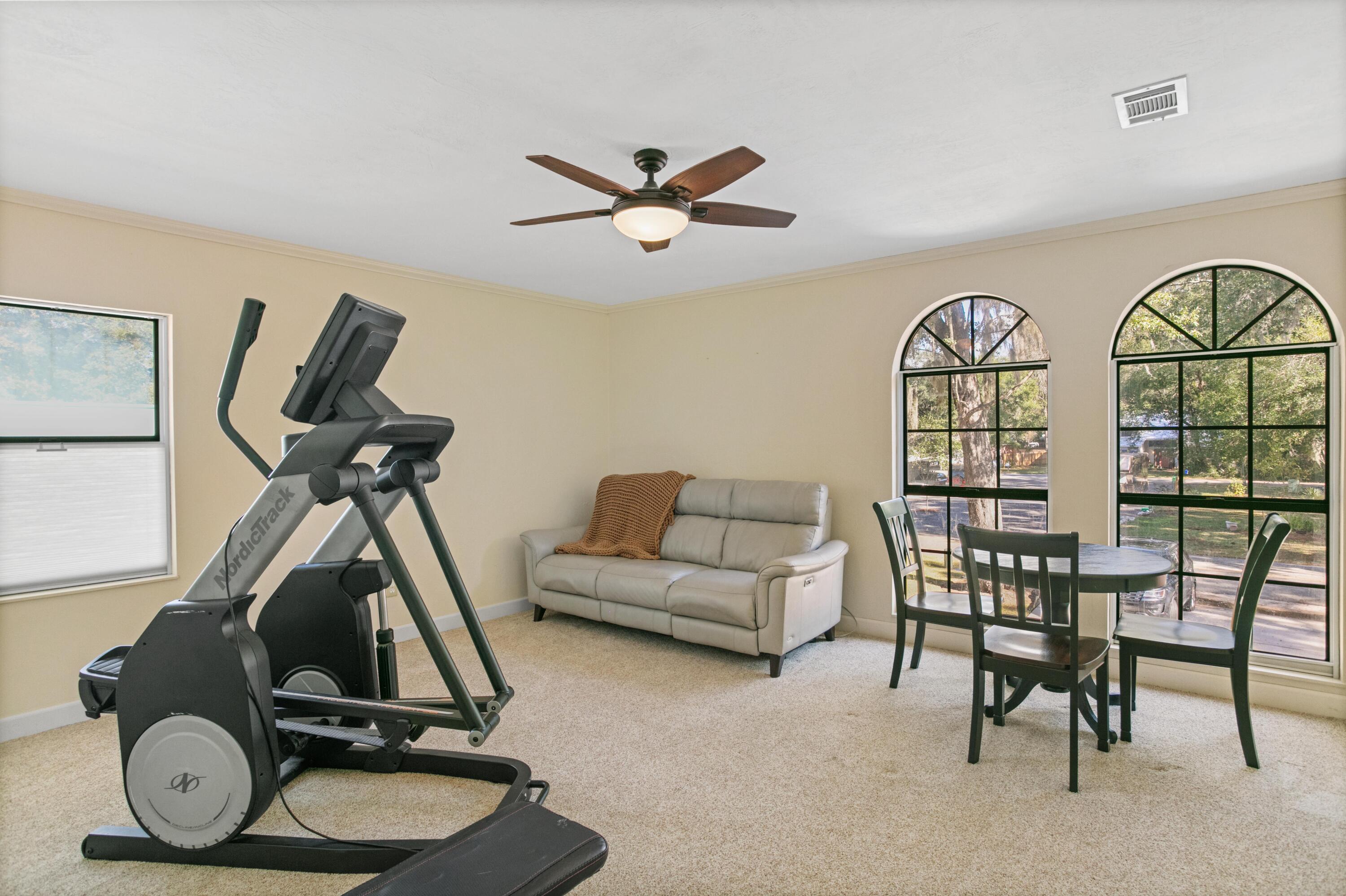41 Waterview Place Freeport, FL 32439 - Photo 43 of 74 a living room with furniture a window and gym equipment
