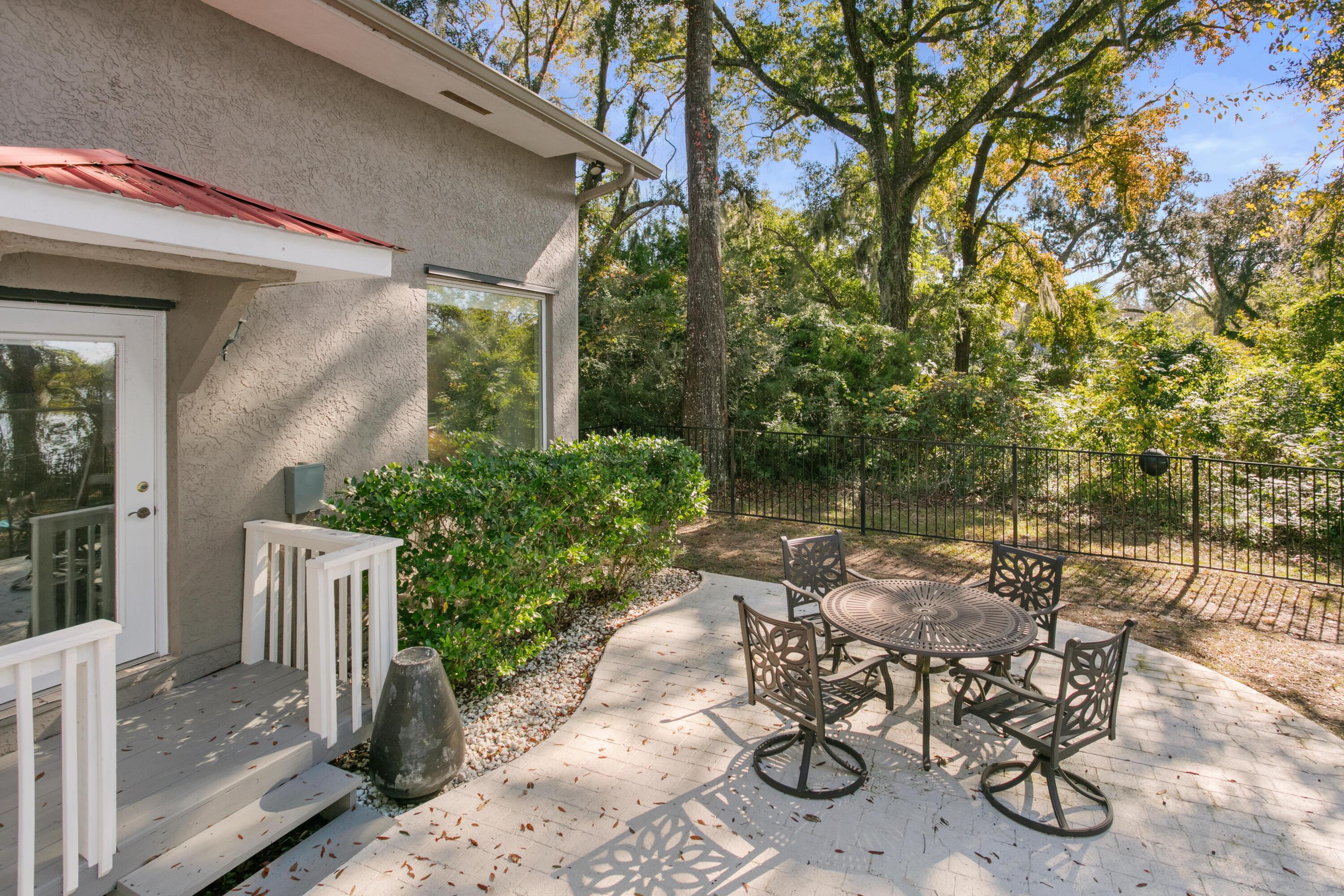 41 Waterview Place Freeport, FL 32439 - Photo 53 of 74 a view of a patio with table and chairs and potted plants