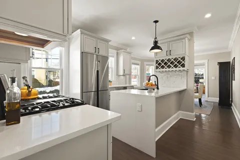 a kitchen with a refrigerator and a stove top oven