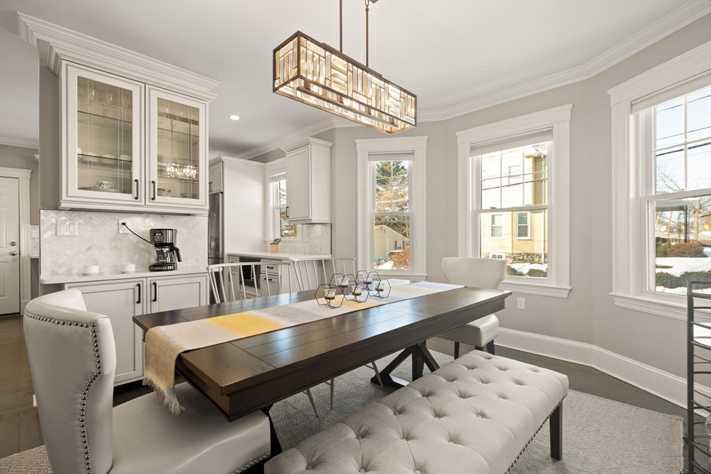 504 Main Street, Unit 1 Watertown, MA 02472 - Photo 14 of 35 a dining room with wooden floor and large windows