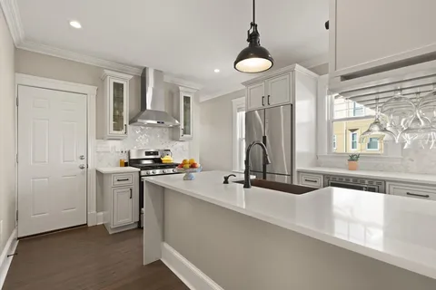 a view of a kitchen with a sink stainless steel appliances and cabinets