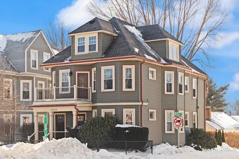 a front view of a building with a yard