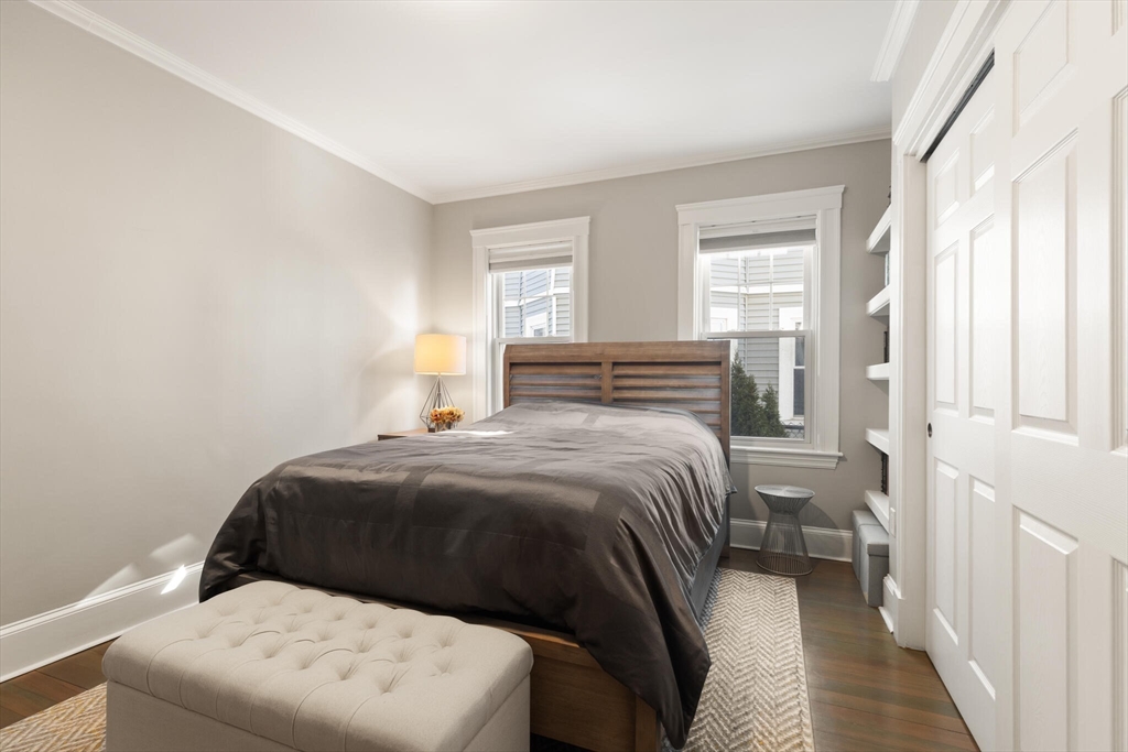 504 Main Street, Unit 1 Watertown, MA 02472 - Photo 21 of 35 a bedroom with a bed and a window