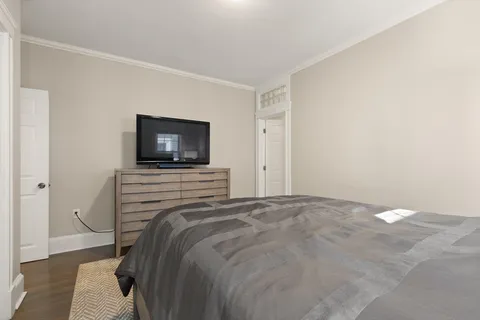 a bedroom with a bed and a flat screen tv