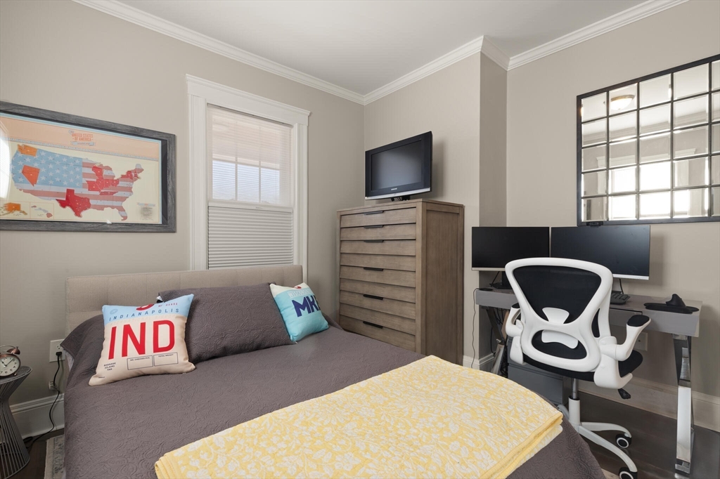 504 Main Street, Unit 1 Watertown, MA 02472 - Photo 24 of 35 a bedroom with a bed and a flat screen tv