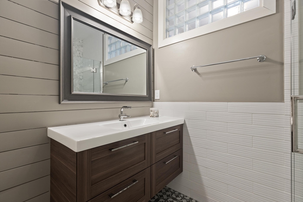 504 Main Street, Unit 1 Watertown, MA 02472 - Photo 26 of 35 a bathroom with a sink and a mirror