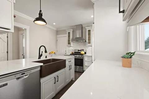 a kitchen with a sink and appliances