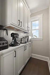 a kitchen with a sink cabinets and a window