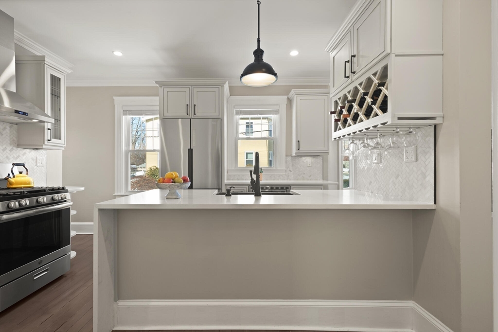 504 Main Street, Unit 1 Watertown, MA 02472 - Photo 7 of 35 a kitchen with stainless steel appliances granite countertop a sink a stove and a wooden floors